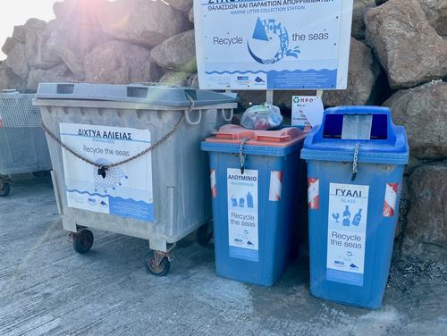 Recycling bins in a Greek harbour